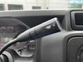 Close-up of the gear shift lever of a 2018 Ford Econoline featuring a textured black handle and gear markings