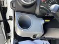 A cup holder in the driver's area of a 2020 Hino 155 featuring a round design and a USB port next to it