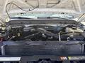 A 2012 Ford F-450 SD engine compartment showing various engine components and hoses