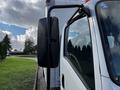 A 2016 Isuzu NPR truck is shown with a focus on its side mirror and cabin door