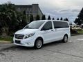 A white 2018 Mercedes-Benz Metris parked on a street with a sleek design and stylish alloy wheels