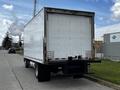 A 2018 Hino 195 truck with a white box cargo unit is parked on the street showing its rear side and distinctive taillights