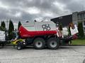 A 2020 Pottinger Impress 155 VC Pro baler with dual wheels and a red and white color scheme designed for efficient hay and grass baling