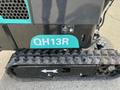 2024 AGT Industrial Green QH13R Mini Excavator displaying the model number QH13R on the side and featuring a rubber track system for mobility