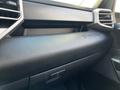 Interior view of a 2023 Toyota Tundra dashboard showcasing a textured black surface with the word TUNDRA embossed on it