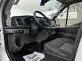 Interior view of a 2020 Ford Transit with a steering wheel dashboard and front seats visible