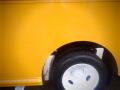 Close-up of a yellow 2008 Freightliner MT45 Chassis wheel and tire showing the wheel rim and tread pattern