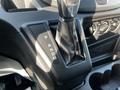 Close-up of the gear shift lever in a 2017 Ford Transit featuring the P R N D M positions clearly labeled