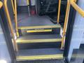 Interior steps of a 2017 Chevrolet Express with yellow handrails and a sign that says Welcome aboard Watch your step