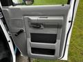 The image shows the interior door panel of a 2009 Ford Econoline featuring a handle a speaker grille and a storage compartment