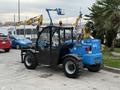 A 2020 Genie GTH-5519 telehandler with a blue and black exterior featuring large rubber tires and a front loading attachment