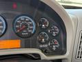 Dashboard of a 2011 International WorkStar showing gauges for speed, fuel, volts, and air pressure with indicator lights illuminated