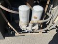 A pair of cylindrical filters mounted on a metal base with connected hoses and a valve system designed for a 2007 International 7300 vehicle