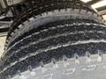 Close-up of three tires from a 2013 Chevrolet Silverado 3500HD showcasing deep treads and rugged rubber surface