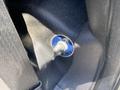 A close-up view of a blue and silver switch labeled "OFF" and "ON" located on a black surface inside a 2015 Ford F-450 SD
