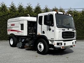 2012 Autocar Xpert street sweeper with a white body and red accents featuring a large cleaning unit attached to the rear and specialized brushes for road maintenance
