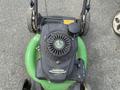 Three Honda Lawnboy mowers and two Stihl line trimmers arranged in a row