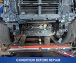 A 2019 RAM 1500 Classic truck positioned on a repair lift exposing the undercarriage and chassis components with wheels removed from the vehicle