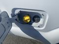 Close-up of the fuel compartment of a 2014 Ford F-250 SD featuring a yellow cap and a gray cover