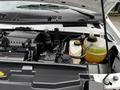 A 2021 Ford E-450 engine compartment displaying various components including a battery reservoir and coolant reservoir