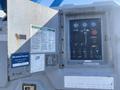 Control panel of a 1997 Genie S-65 4X4 with gauges buttons and switches for operation and safety instructions displayed on a metal surface