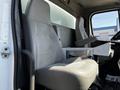 Cab interior of a 2012 Freightliner M2 112 featuring two gray leather seats and a central console