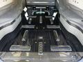 The interior of a 2013 Lincoln MKT featuring a polished black floor with metallic accents and multiple fasteners arranged in a grid pattern