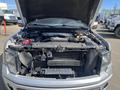 A 2014 Ford F-150 with an open hood displaying the engine compartment and various automotive components inside