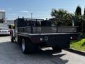 A 2016 Ford F-550 with a flatbed truck design featuring a mesh rear gate and several lights on the back