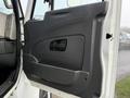 The interior door panel of a 2016 International 7400 featuring a sleek design with a handle and armrest in a dark color