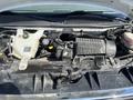 Engine compartment of a 2016 GMC Savana showing various components including the engine cover and fluid reservoirs