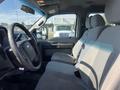 Interior of a 2015 Ford F-450 SD showing the driver's seat and passenger seat with gray fabric upholstery and armrests