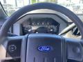 Steering wheel view of a 2015 Ford F-450 SD with dashboard gauges visible including speedometer and fuel gauge