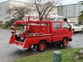 A red 2001 Toyota Dyna configured with firefighting equipment including hoses and equipment mounted on the truck bed