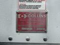 A metal identification plate with the text "Manufactured by Collins" and additional information including a serial number and contact details