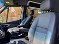 The interior of a 2023 Mercedes-Benz Sprinter featuring two black leather seats with adjustable headrests and armrests
