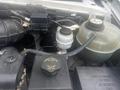 2004 Ford Econoline engine compartment showing power steering fluid reservoir coolant reservoir and various engine components