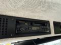 A Panasonic J25 car stereo with buttons for manual tuning and auto reverse displayed on a textured panel