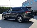 A 2017 Kia Sorento in dark gray with chrome accents and sporty wheels, showing a side view with a sleek design and modern features