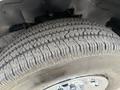 Close-up of a textured tire on a 2021 Chevrolet Express showcasing its tread design and wheel rim