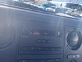 Dashboard of a 2014 Ford F-250 SD showing a radio display with buttons for volume and tuning