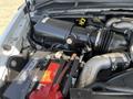 Close-up view of the engine compartment of a 2008 Ford F-450 SD showing the air intake system battery and various hoses and components