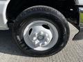 Close-up of a 2019 Ford Econoline wheel and tire featuring a white rim and black rubber tire with visible tread pattern