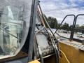 A 2018 John Deere 350 heavy machinery with hydraulic hoses visible on the side and a clear view of the cab interior