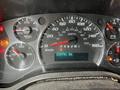 Dashboard of a 2014 GMC Savana showing speedometer fuel gauge and various indicator lights with a digital display reading 234741 km