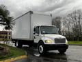 A 2018 Freightliner M2 106 box truck with a white exterior and a closed cargo area is parked with its front facing the viewer