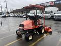 A red 2010 Kubota F3680 lawn mower with a large cutting deck and a cabin for the operator in a parking lot