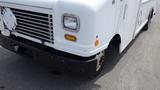 A white 2011 Ford Econoline with a distinctive front grille and a single headlight on the right side