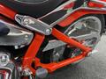 Close-up view of the frame and chrome details of a 2024 Harley Davidson Fat Boy motorcycle with a red and silver color scheme