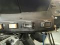 Dashboard controls of a 2016 International 7600 featuring buttons for spread and plow functions along with dump controls
